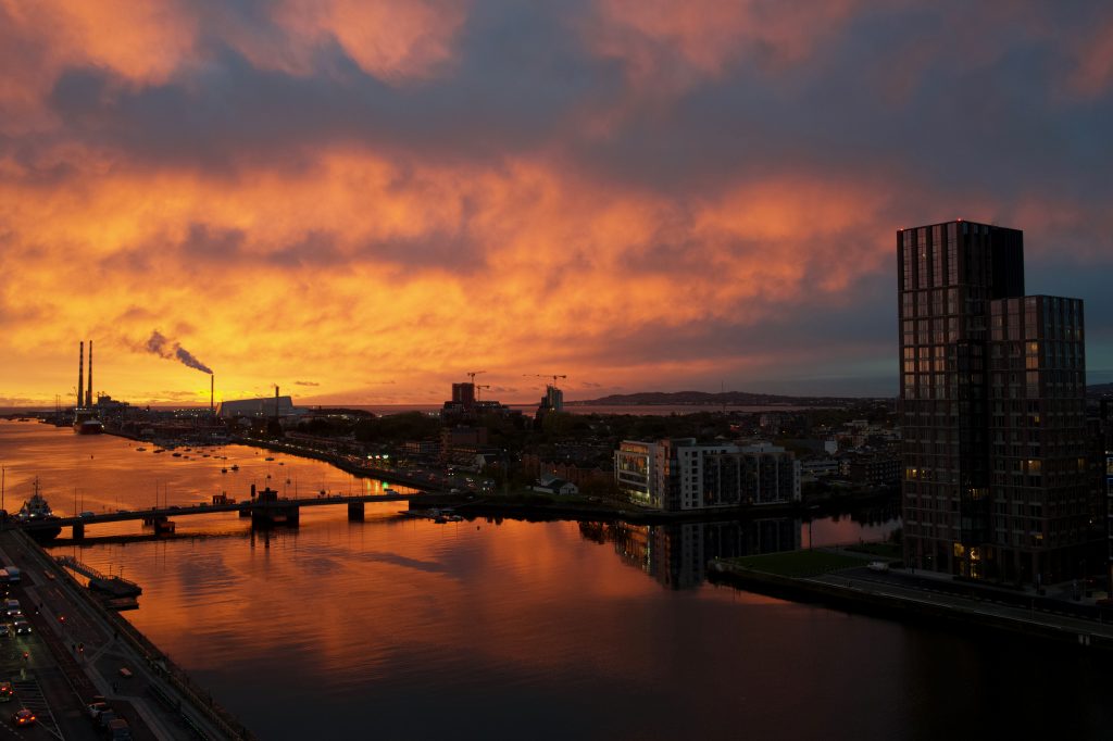 A deep orange sunrise over the docklands of Dublin.